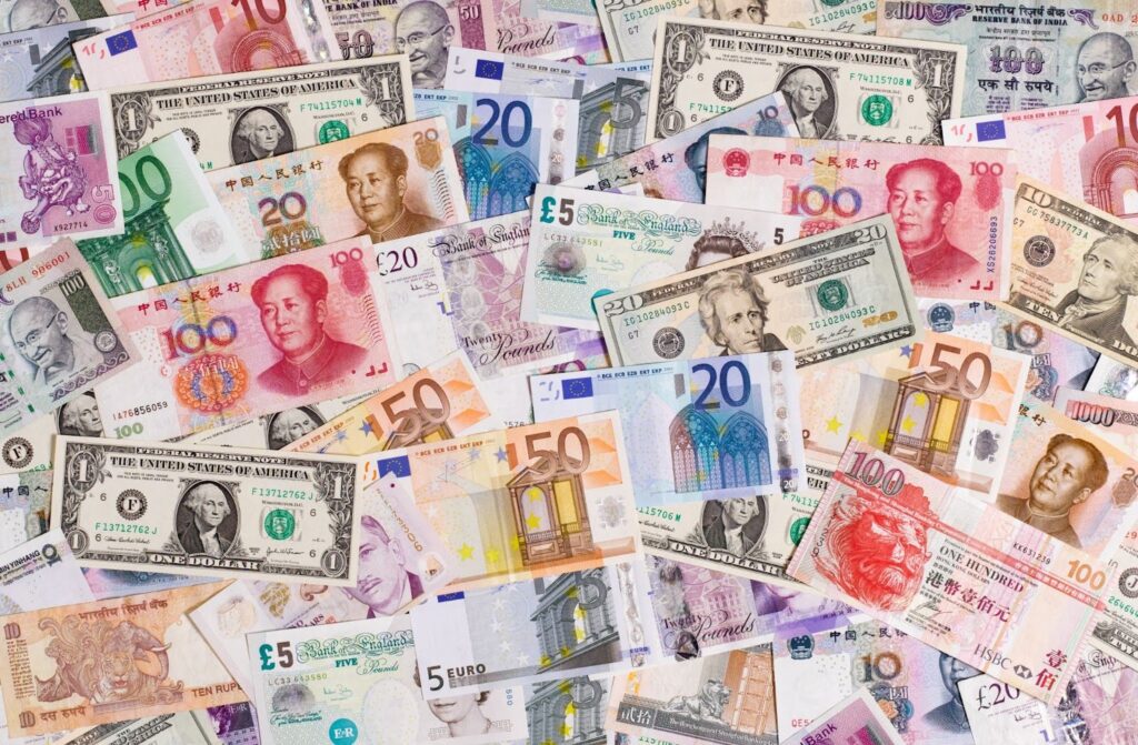 Foreign currency bank notes, including yuan, British pounds, rupees, US dollars, and rubles.