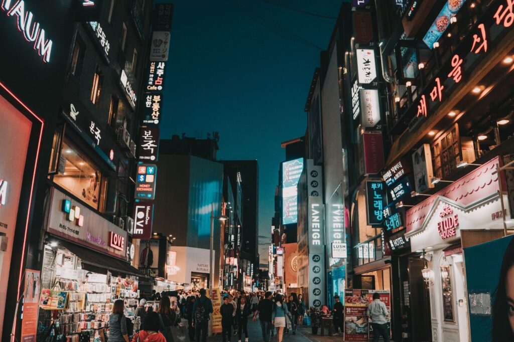 A busy South Korean shopping district at night.